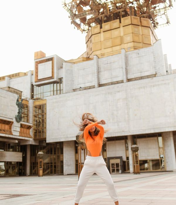 Woman feeling energetic and balanced in a bright, open space.